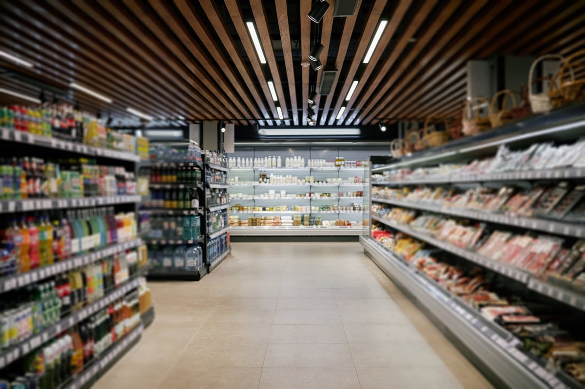 Supermarket Aisle with Various Products Displayed on Well-Organized Shelves