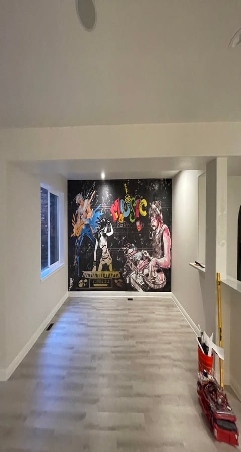 Modern hallway with colorful rock band wall mural featuring musicians and instruments on black background, polished concrete floor