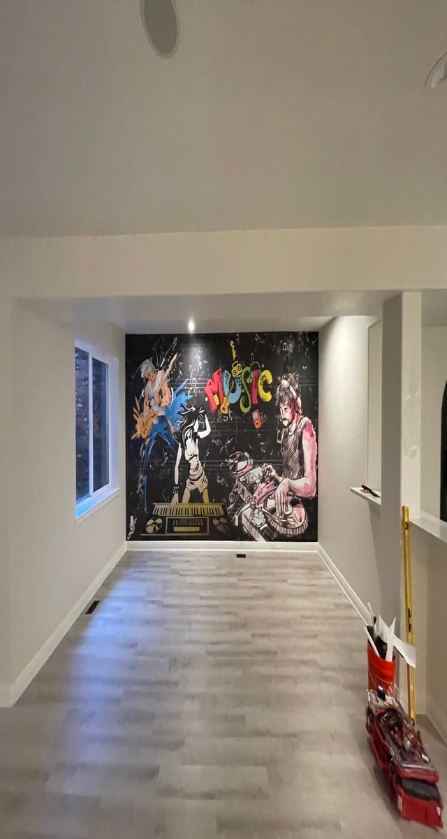 Modern hallway with colorful rock band wall mural featuring musicians and instruments on black background, polished concrete floor