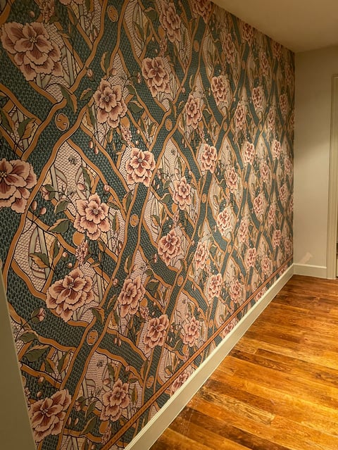 Pink peonies and floral wallpaper in hallway