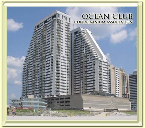 Ocean Club Condominium Association high-rise beachfront building with white and gray curved towers under blue sky