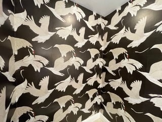 Tessellating pattern of white and black birds in flight with interlocking wings and bodies