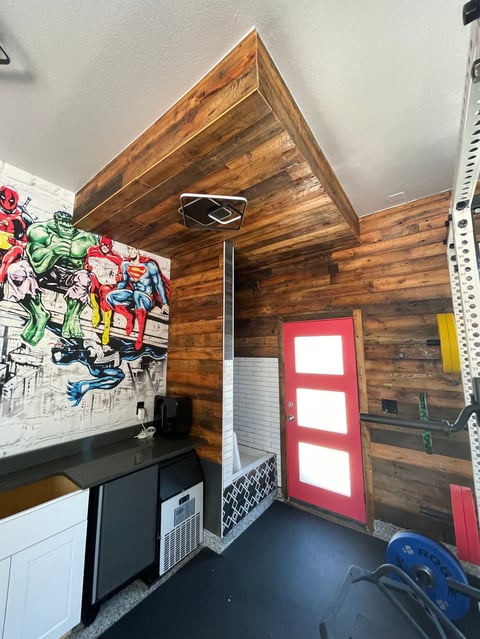 Modern mountain property exterior with large windows showcasing snowy Aspen landscape and evergreen trees